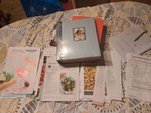 Image of Binder and recipes on a table with a geometric patterned tablecloth