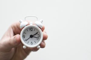 Image of hand holding small white alarm clock I'm thinking "Phew its finally Friday!"Finally Friday