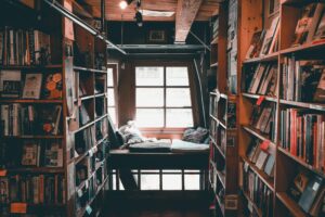 Image of seating area amongst shelves and shelves of books