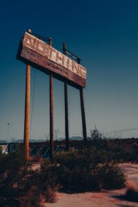 Nothing    Image of an old sign in the skyline it says "Nothing" it looks like an old desert road. 