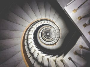 Image of white spiral stair case in a swirl like a snail shell the stairs look like layers